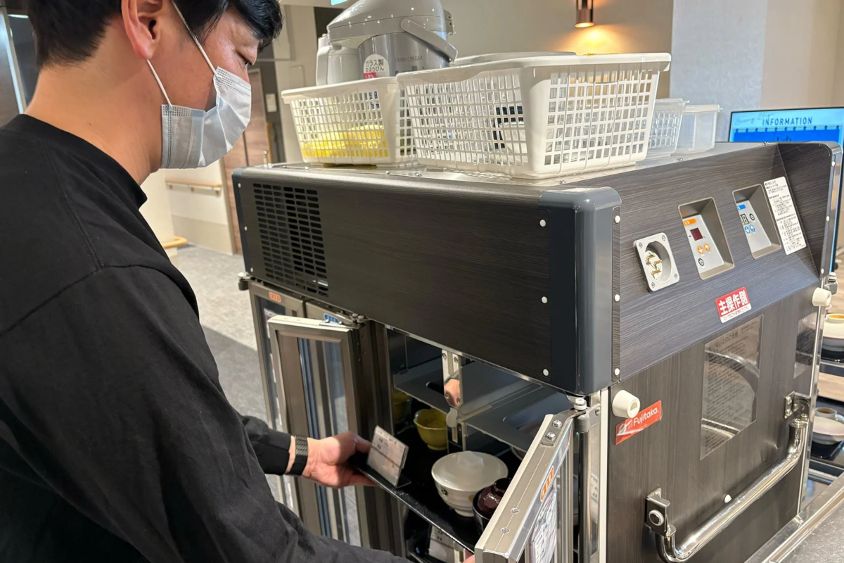 配膳用の保温カートから食器を取り出している様子